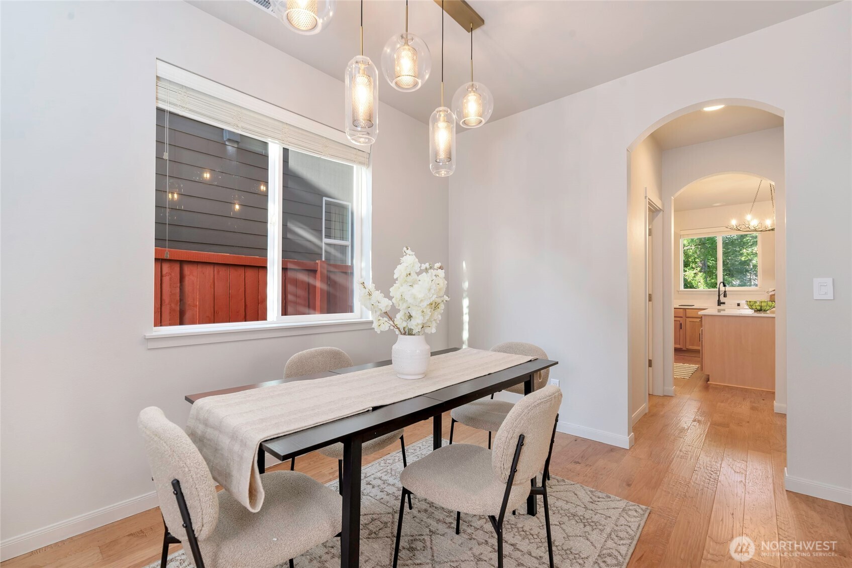 11290 Borgen Loop Northwest Gig Harbor, WA 98332 - Photo 11 of 26 a dining room with furniture and wooden floor