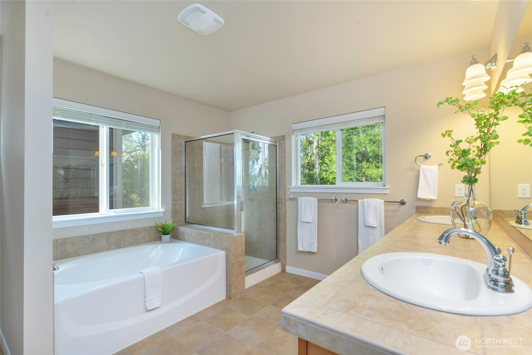 11290 Borgen Loop Northwest Gig Harbor, WA 98332 - Photo 16 of 26 a bathroom with a tub sink and mirror