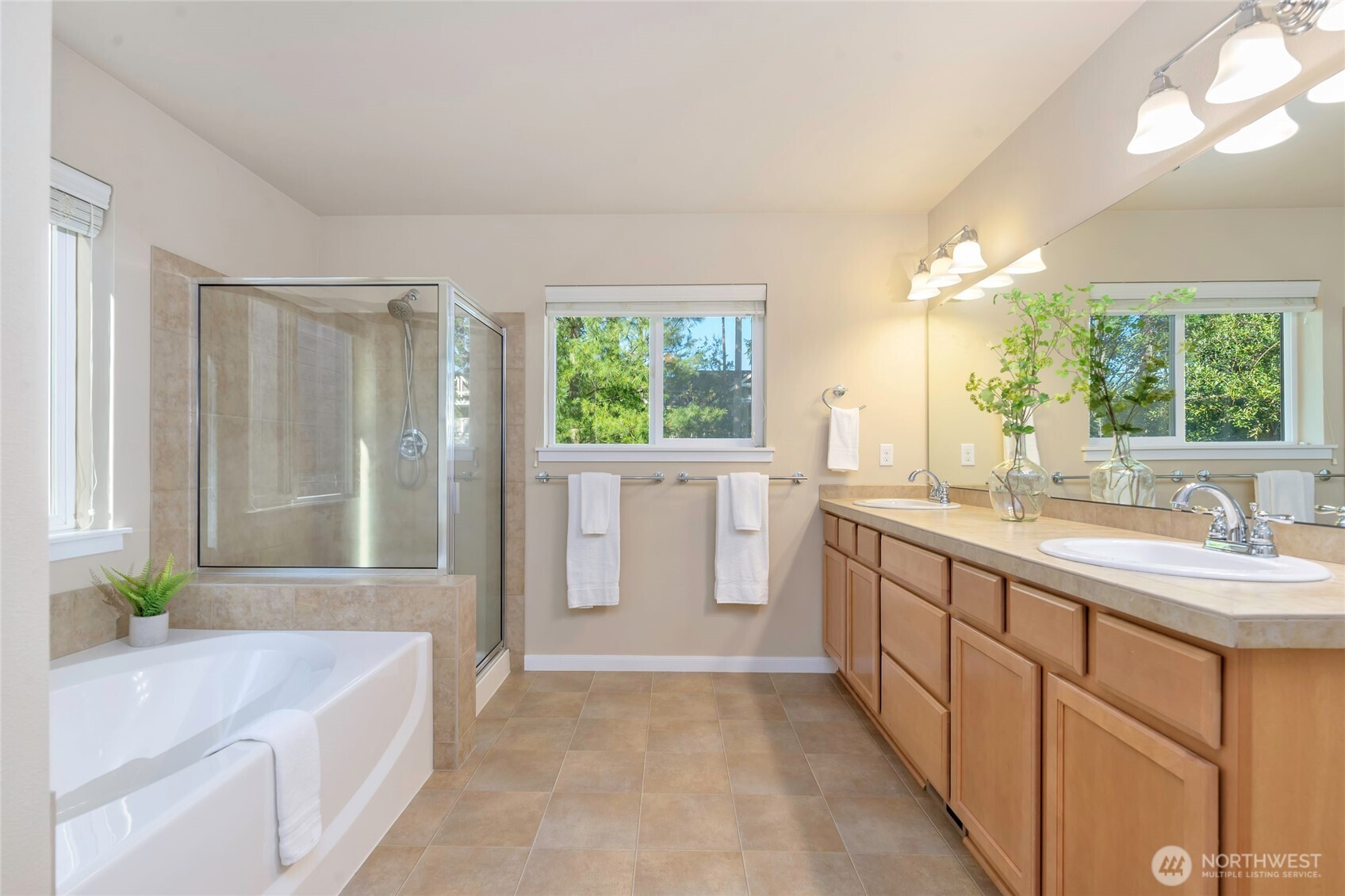11290 Borgen Loop Northwest Gig Harbor, WA 98332 - Photo 18 of 26 a spacious bathroom with a bathtub sink and mirror