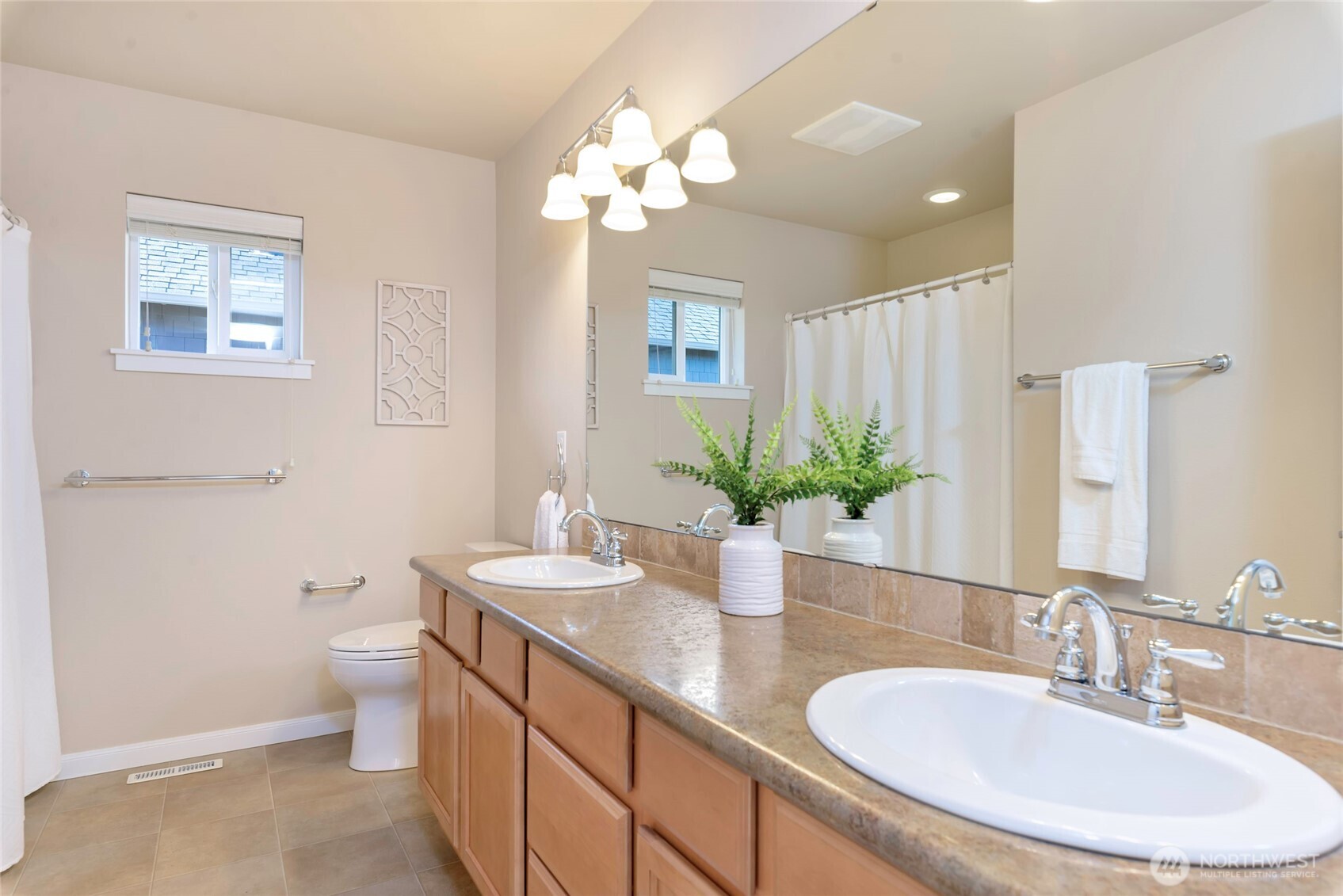 11290 Borgen Loop Northwest Gig Harbor, WA 98332 - Photo 20 of 26 a bathroom with a double vanity sink toilet and a mirror