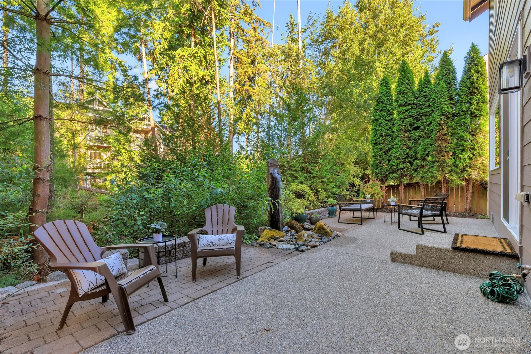11290 Borgen Loop Northwest Gig Harbor, WA 98332 - Photo 23 of 26 a view of a chairs and table in the back yard