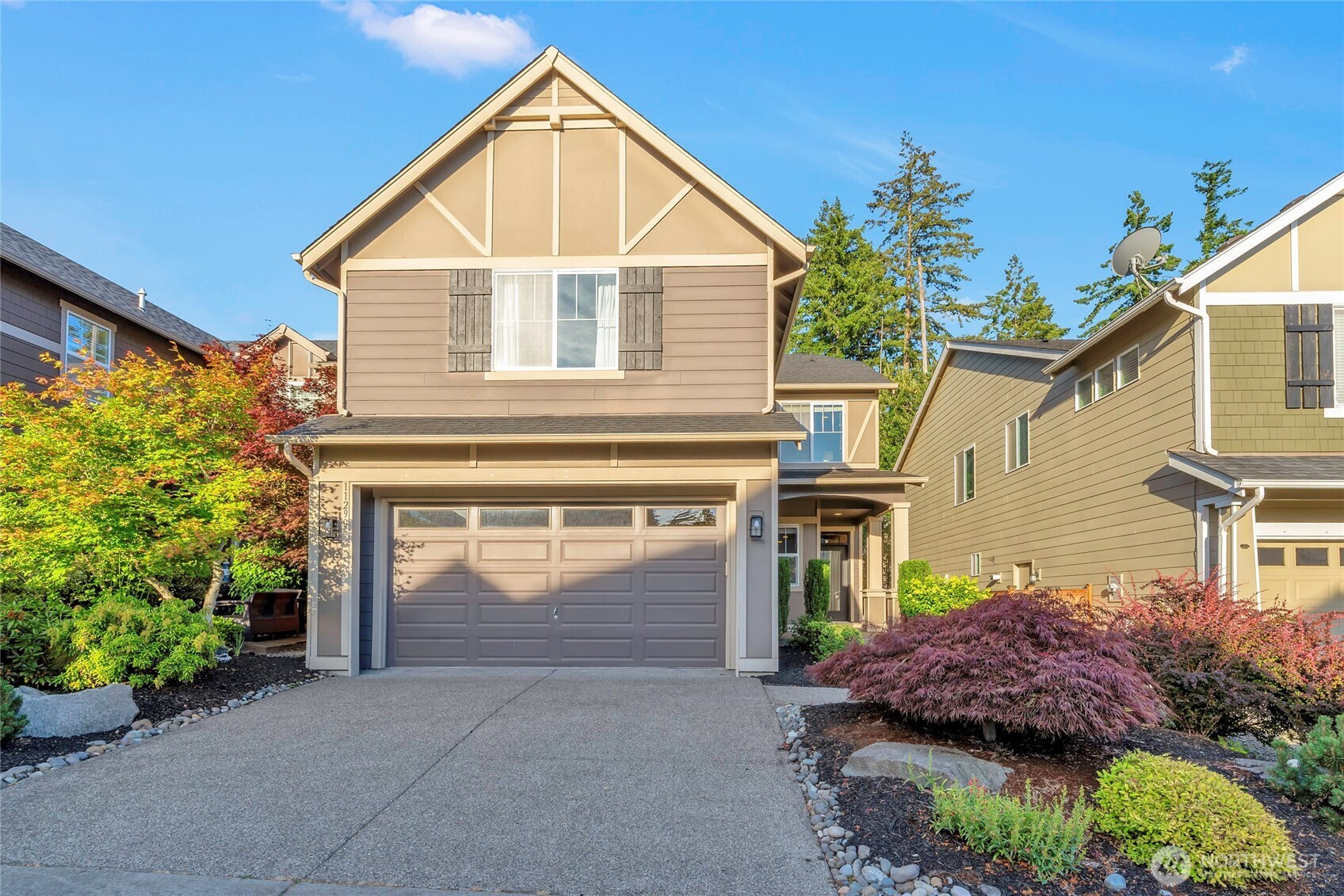 11290 Borgen Loop Northwest Gig Harbor, WA 98332 - Photo 3 of 26 a view of a house with potted plants and a yard