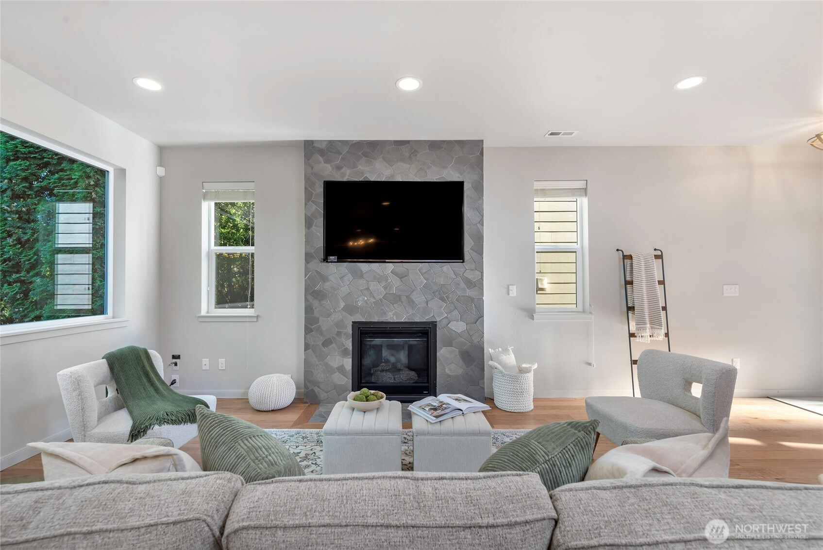 11290 Borgen Loop Northwest Gig Harbor, WA 98332 - Photo 5 of 26 a living room with furniture a fireplace and a flat screen tv