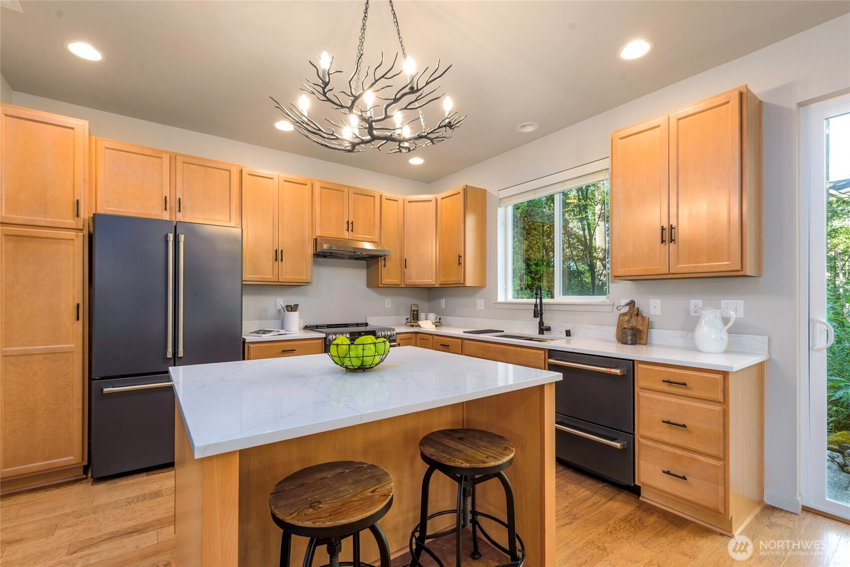 11290 Borgen Loop Northwest Gig Harbor, WA 98332 - Photo 8 of 26 a kitchen with a table chairs refrigerator and cabinets
