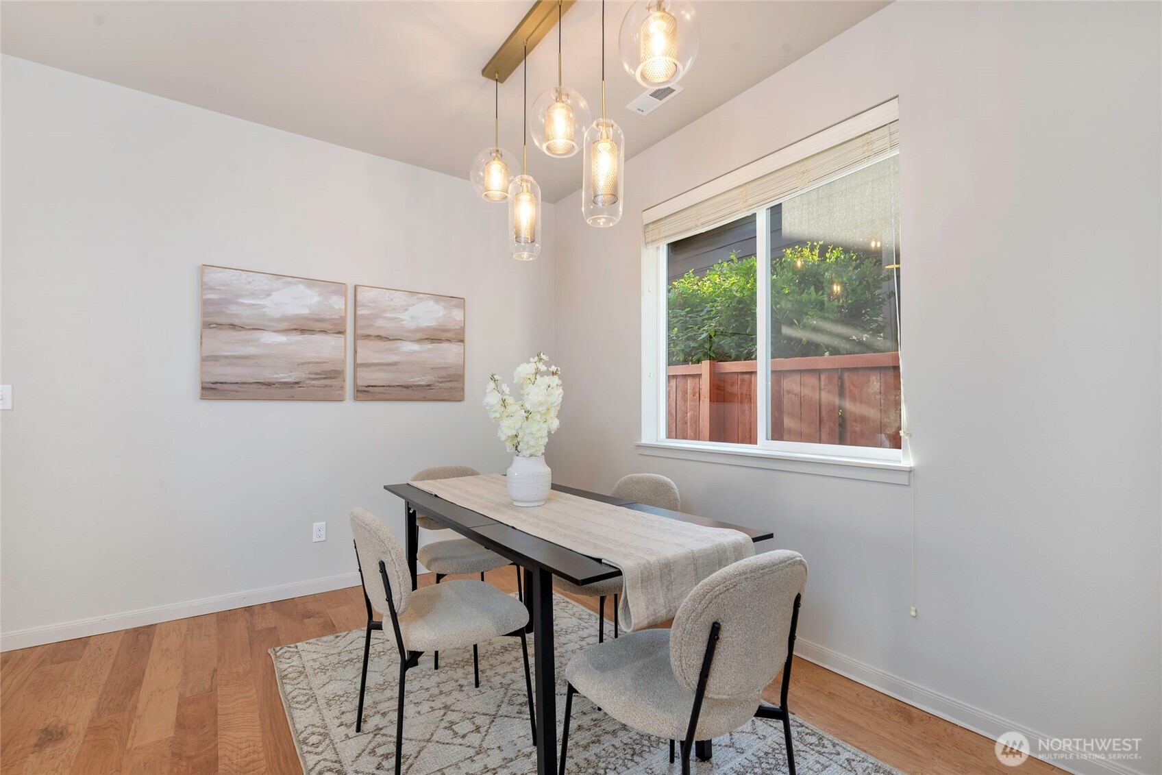 11290 Borgen Loop Northwest Gig Harbor, WA 98332 - Photo 10 of 26 a dining room with wooden floor and chandelier