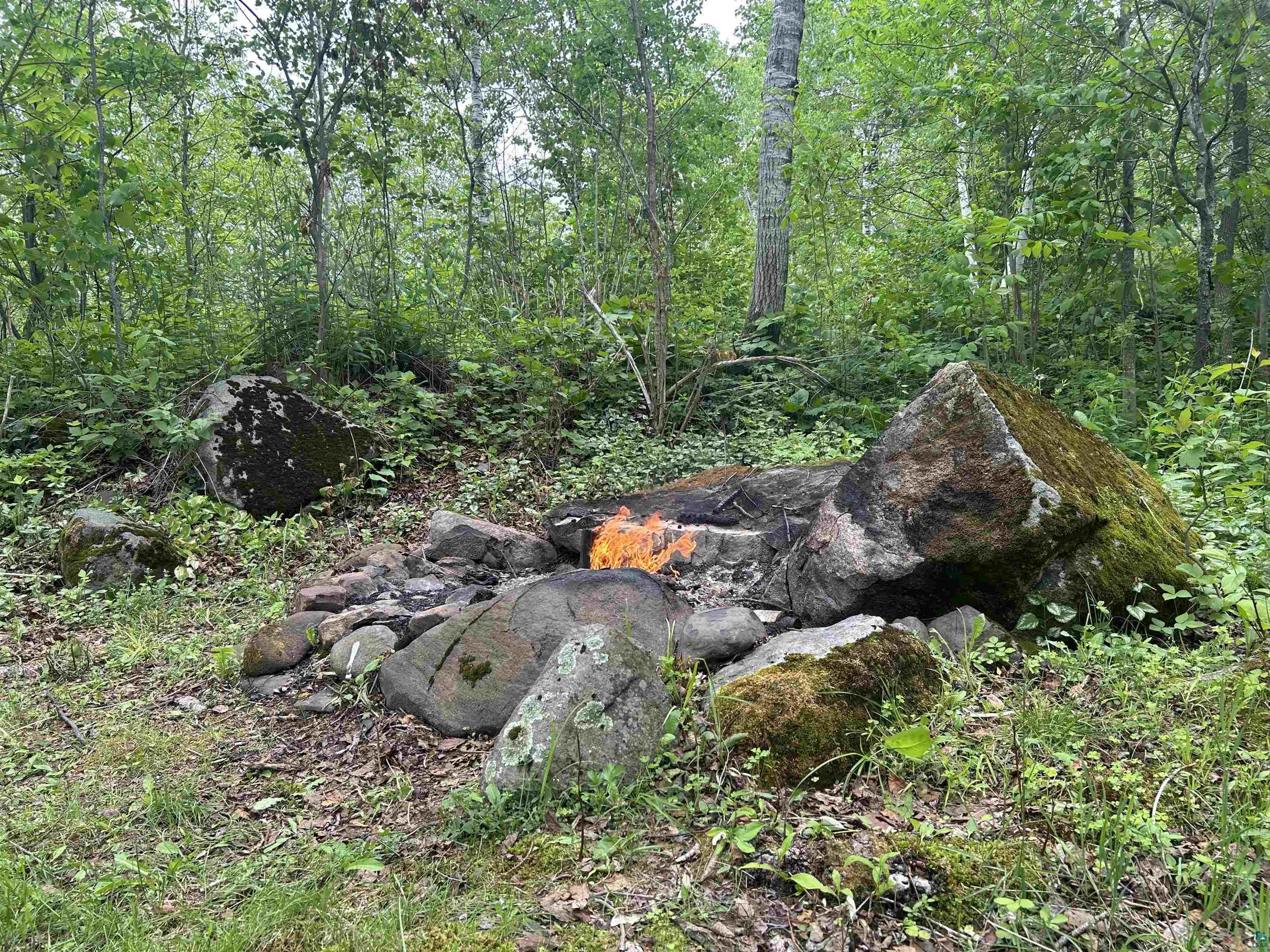 3616 Lavaque Road Hermantown, MN 55811 - Photo 5 of 43 Wooded landscape featuring natural rock formations and an established fire pit