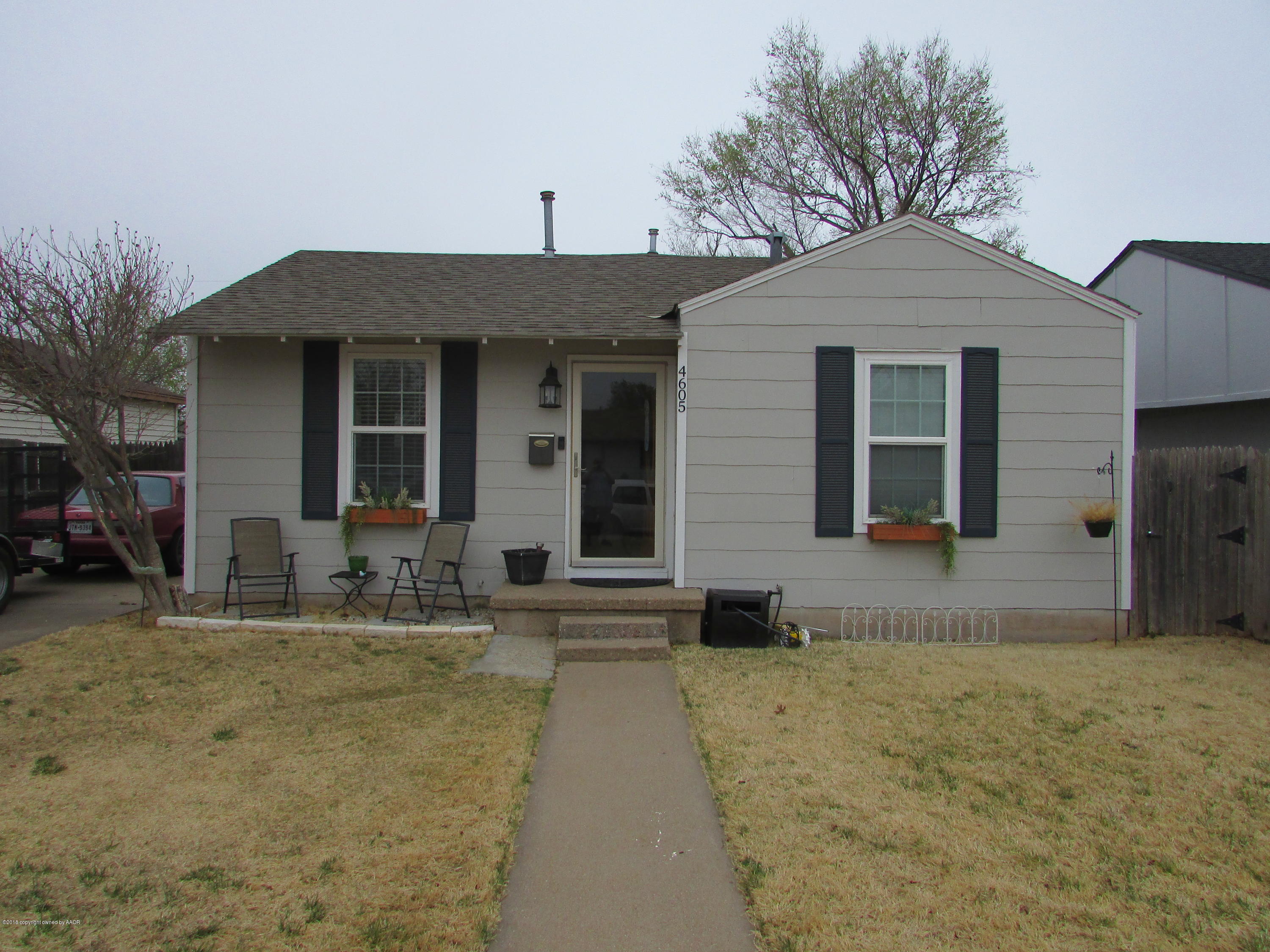4605 South Travis Street Amarillo, TX 79110 - Photo 1 of 17 a front view of a house with garden