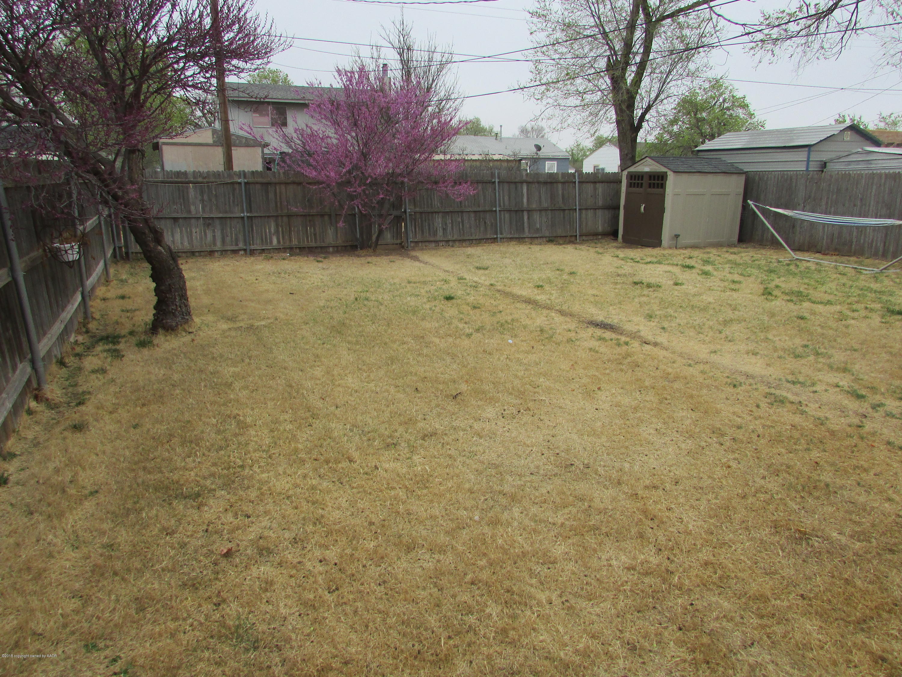 4605 South Travis Street Amarillo, TX 79110 - Photo 15 of 17 a backyard of a house with lots of green space
