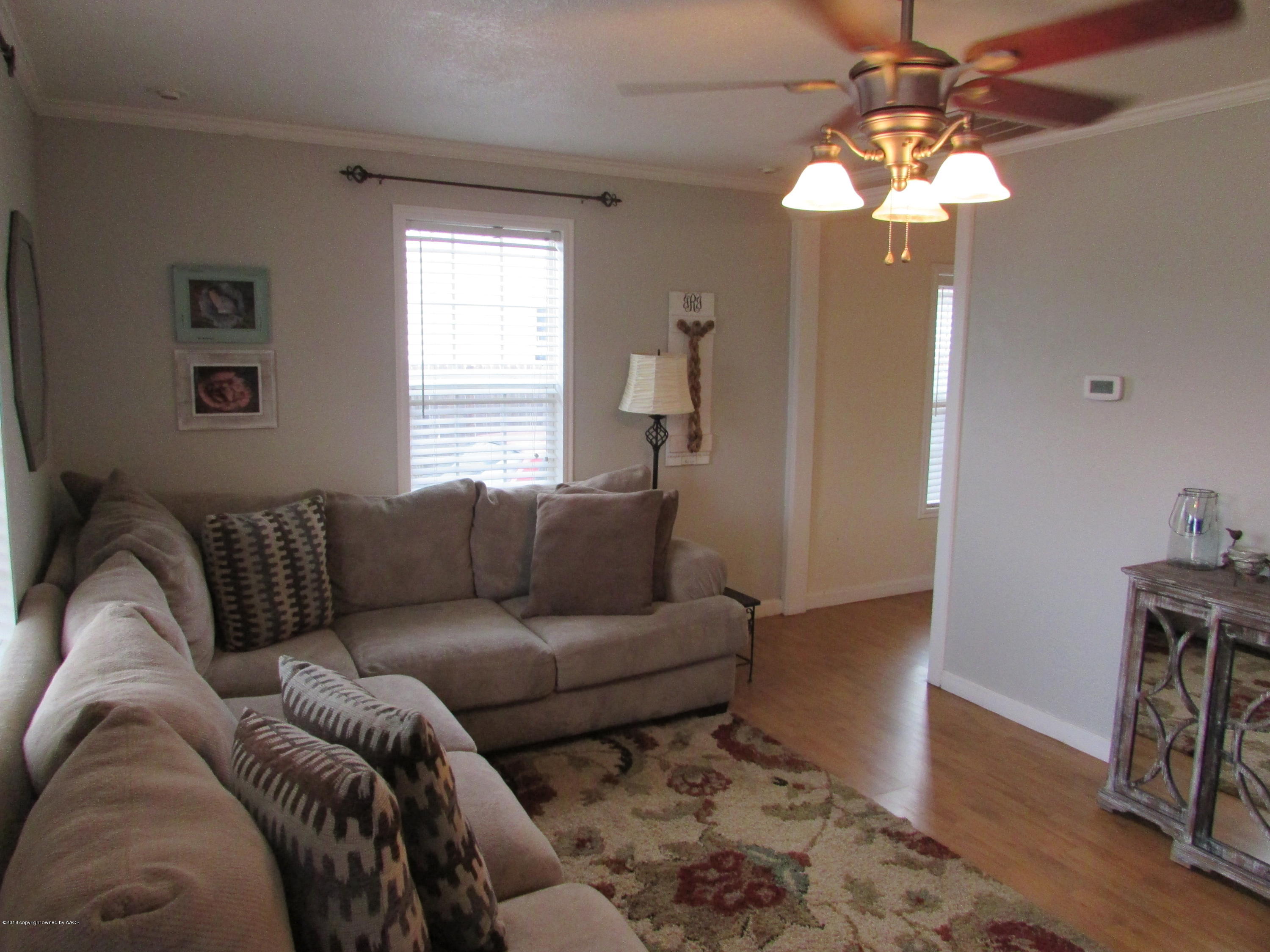 4605 South Travis Street Amarillo, TX 79110 - Photo 3 of 17 a living room with furniture and a window