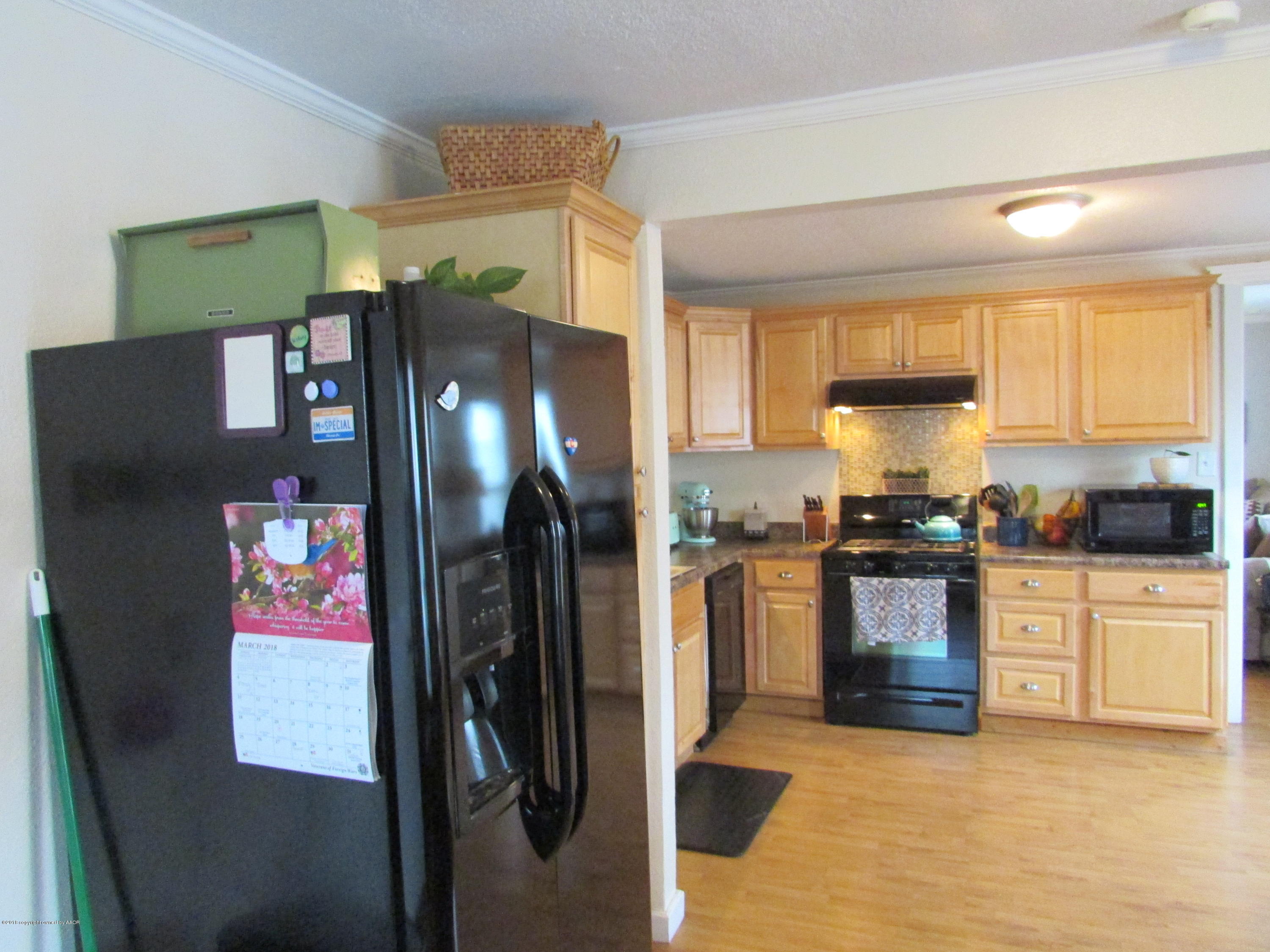 4605 South Travis Street Amarillo, TX 79110 - Photo 5 of 17 a kitchen with stainless steel appliances granite countertop a refrigerator and a stove