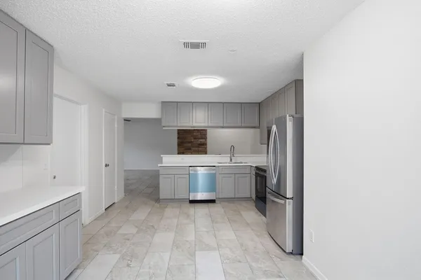 a kitchen with a sink and refrigerator