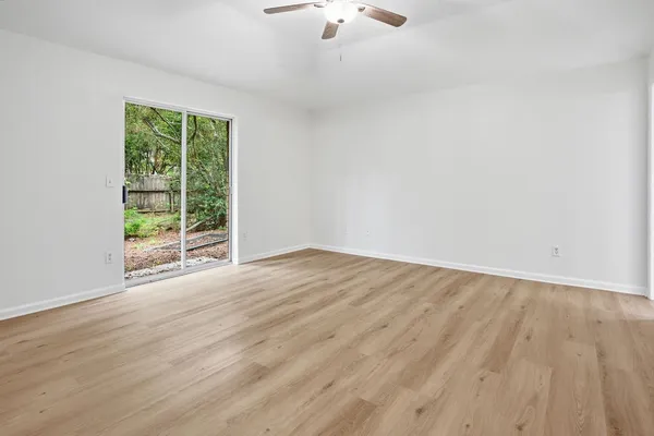 wooden floor in an empty room with a window