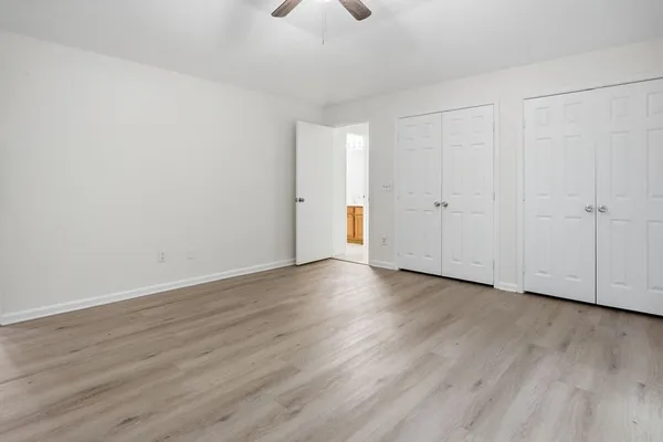 a view of an empty room and wooden floor