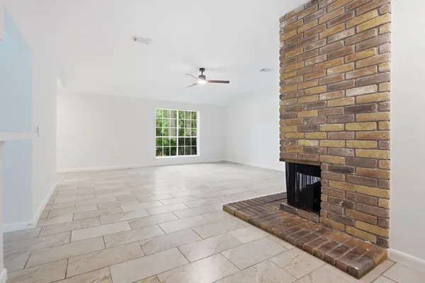 a view of an empty room with a fireplace