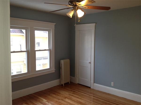 20-22 Standish Street Springfield, MA 01108 - Photo 18 of 27 a view of an empty room with wooden floor and a window