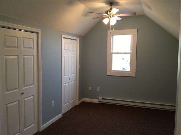 20-22 Standish Street Springfield, MA 01108 - Photo 21 of 27 an empty room with windows and fan