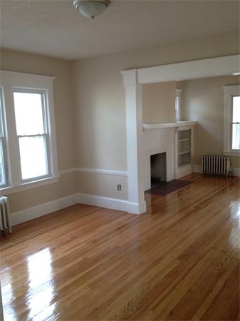 20-22 Standish Street Springfield, MA 01108 - Photo 7 of 27 an empty room with wooden floor fireplace and windows