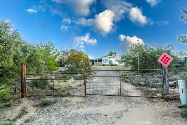 a view of a white house with a yard