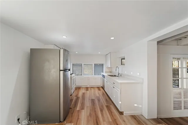 a large kitchen with a lot of counter space and a refrigerator