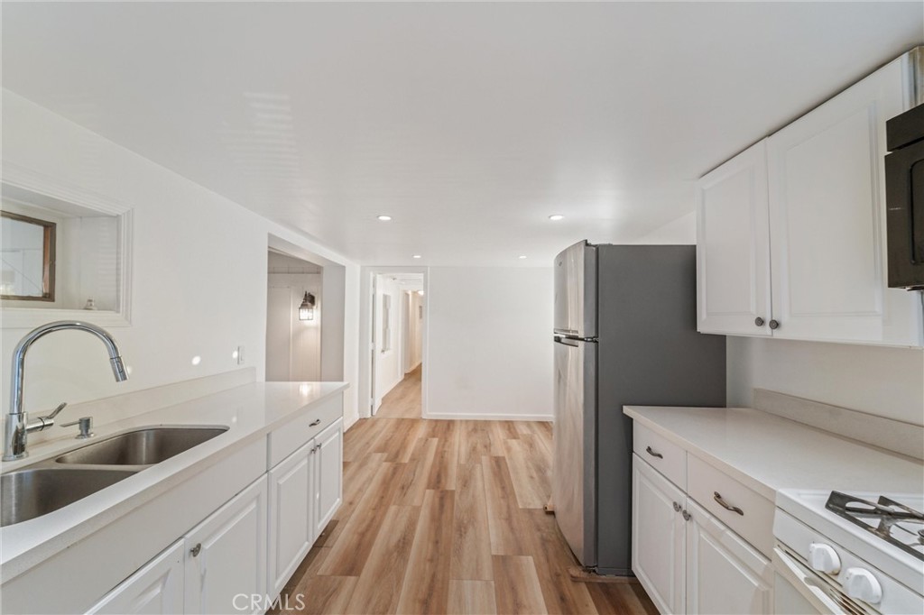 44270 Arya Court Anza, CA 92539 - Photo 9 of 64 a kitchen with a refrigerator sink and cabinets