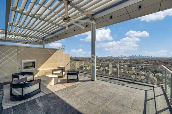 a roof deck with table and chairs