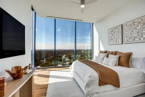 a bedroom with a bed and a flat screen tv