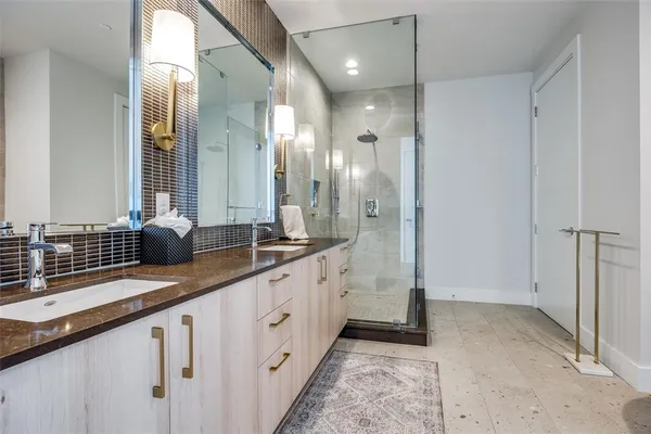 a bathroom with double sink and a mirror