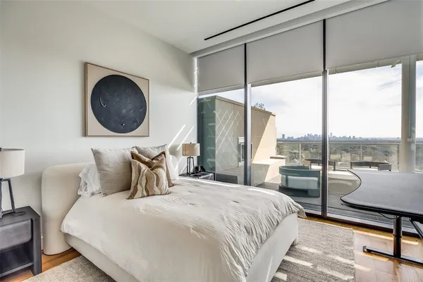 a bedroom with a large window and a bed