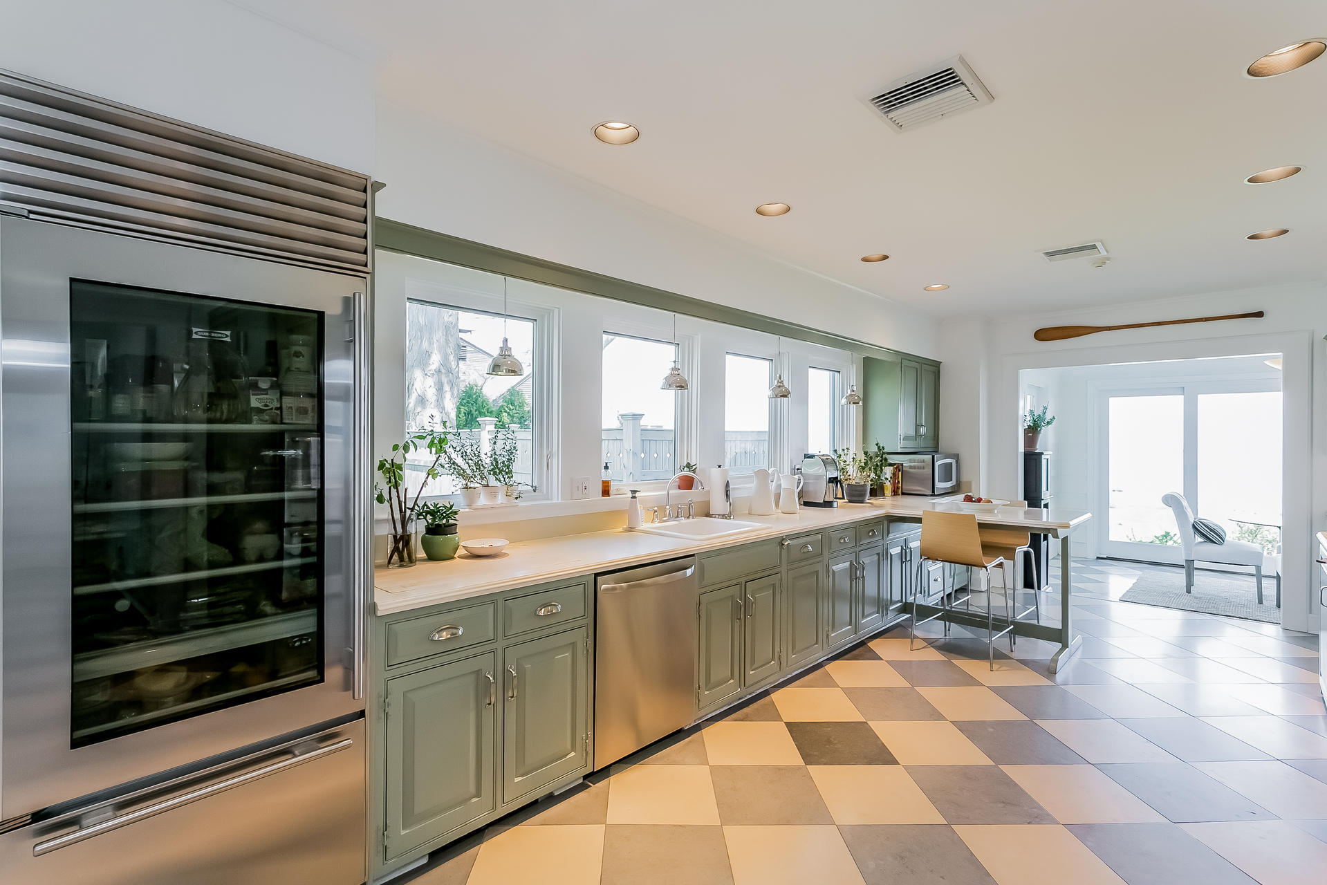229 Long Neck Point Road Darien, CT 06820 - Photo 16 of 44 a large kitchen with a counter space a sink and chairs