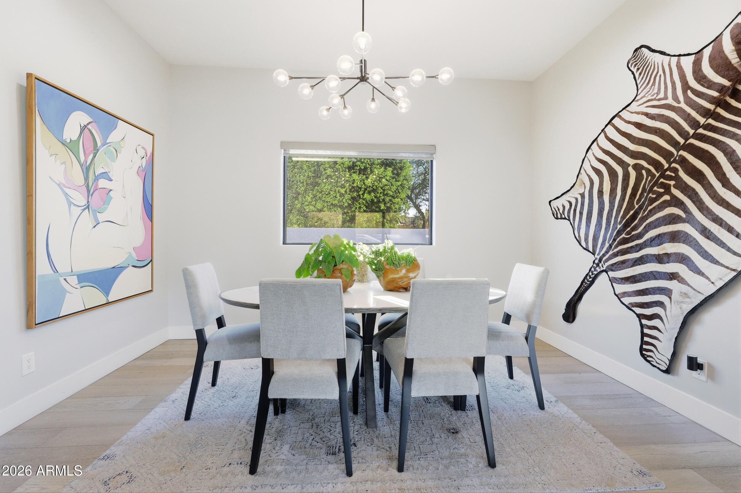4417 East Mountain View Road Phoenix, AZ 85028 - Photo 12 of 41 a view of a dining room with furniture and a chandelier
