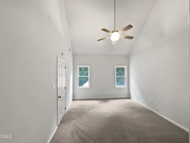 a view of room with a ceiling fan and window