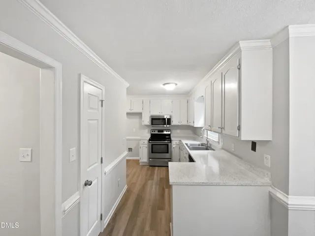 a kitchen with cabinets and a stove top oven