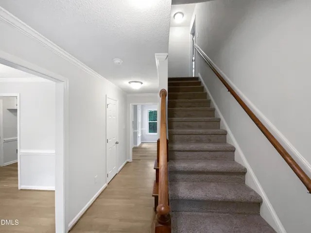 a view of entryway and hall with wooden floor
