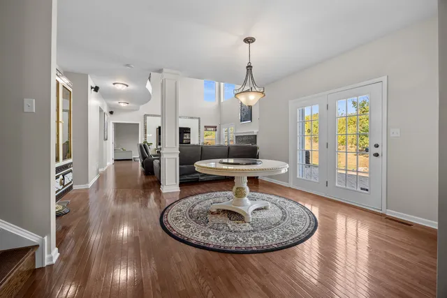 a view of a livingroom with furniture wooden floor a chandelier