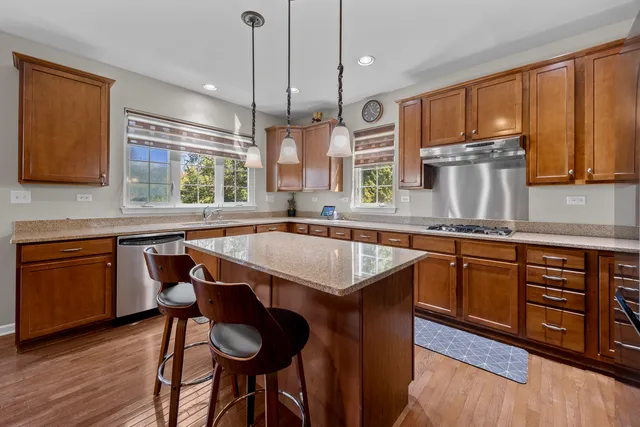a kitchen with a stove a sink and a wooden cabinets