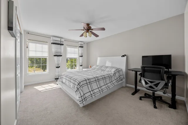 a bedroom with a bed a chair and a chandelier