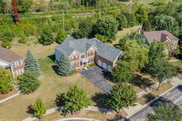 an aerial view of a house with yard swimming pool and outdoor seating