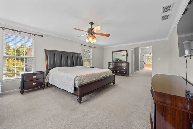 a bedroom with a bed and dresser with mirror