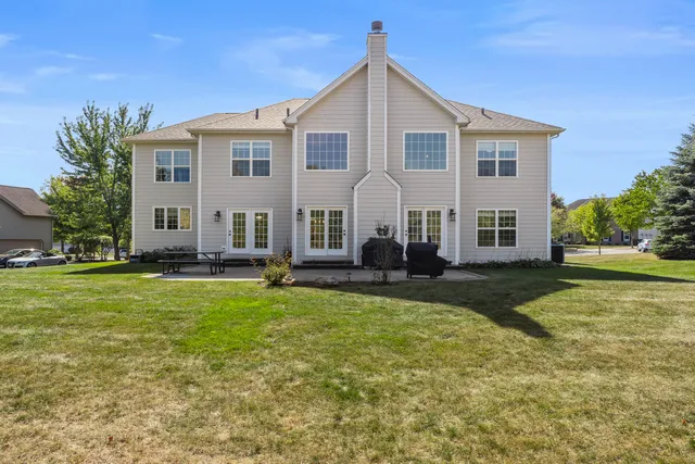 a front view of house with yard and trees