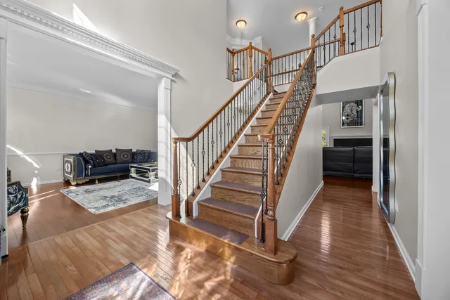 a view of entryway and hall with wooden floor