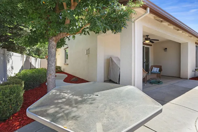 a kitchen with kitchen island granite countertop a sink window and cabinets