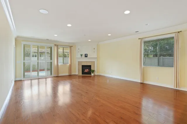 a view of an empty room with a fireplace and a window