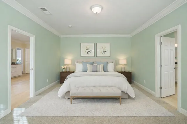 a bedroom with a bed and a painting on the wall