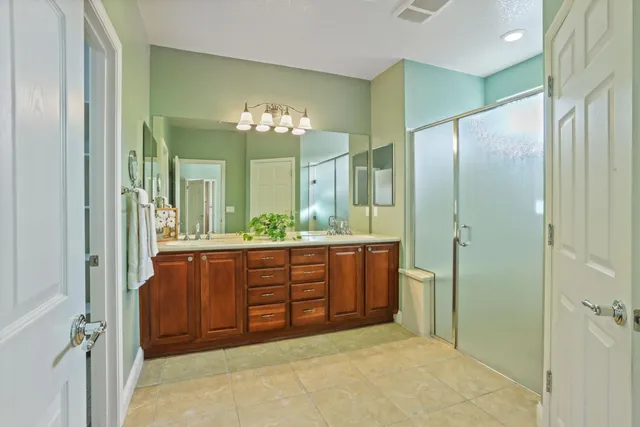 a bathroom with a double vanity sink and a mirror