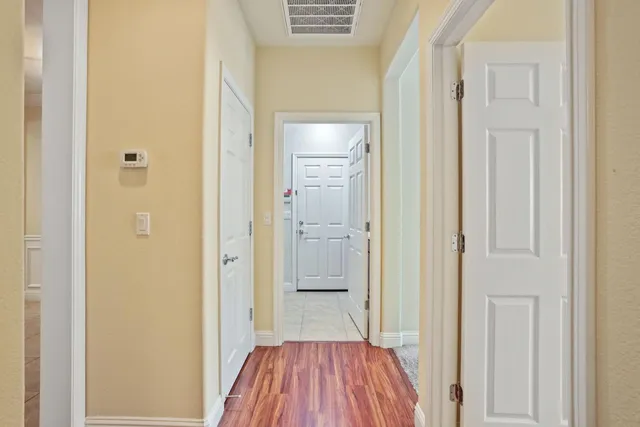 an empty room with closet and a chandelier fan