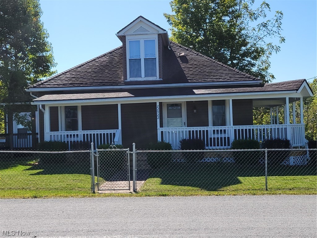 22922 Putney Ridge Road Quaker City, OH 43773 - Photo 2 of 31 View of front of home with a porch and a front lawn