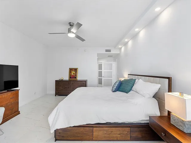 a bedroom with a bed and a tv