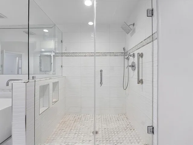 a bathroom with a shower and a glass door