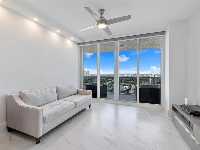 a living room with furniture ceiling fan and a rug