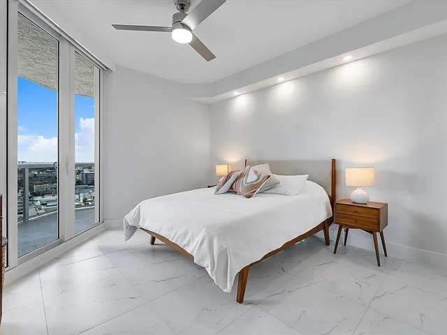 a bedroom with a bed and a lamp with window